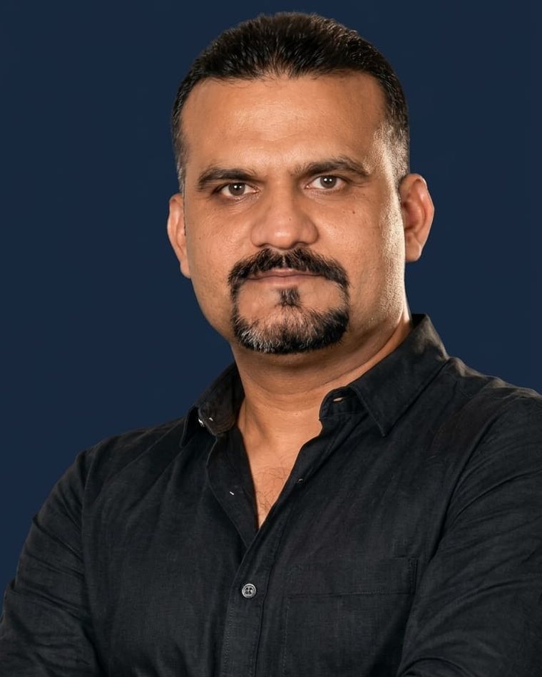 Vijay K. Sharma, known as VS Sir, with arms crossed